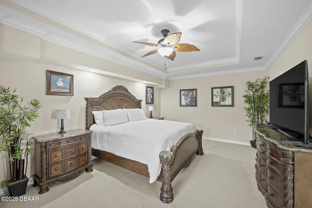 carpeted bedroom with ceiling fan, visible vents, baseboards, ornamental molding, and a raised ceiling