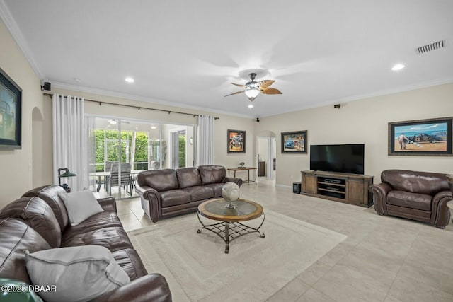 living room with visible vents, arched walkways, and crown molding