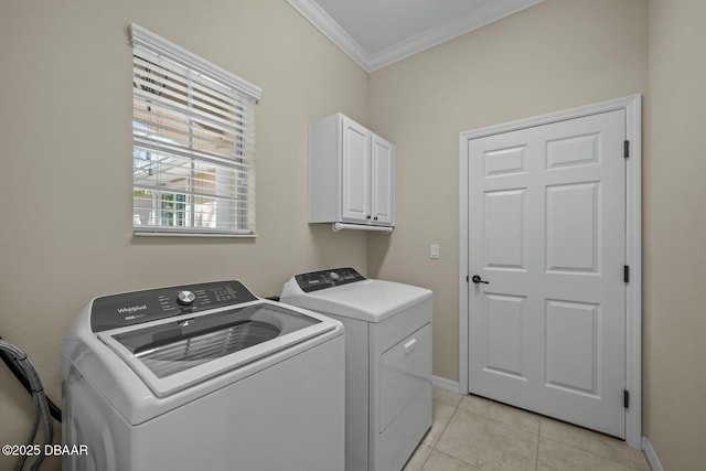 laundry area with light tile patterned floors, cabinet space, ornamental molding, separate washer and dryer, and baseboards