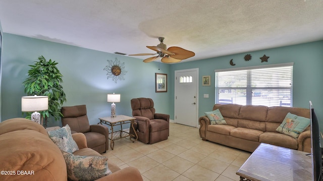 tiled living room featuring ceiling fan and a textured ceiling