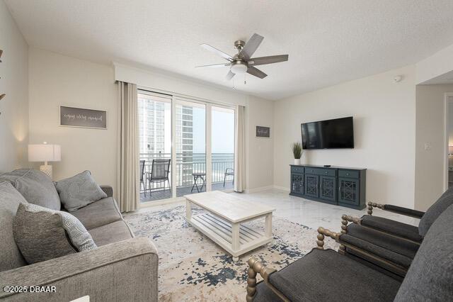 living room featuring a ceiling fan and baseboards