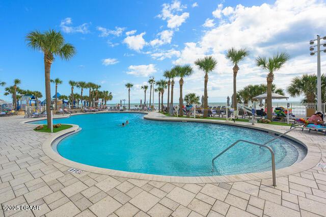 community pool featuring a patio area and fence