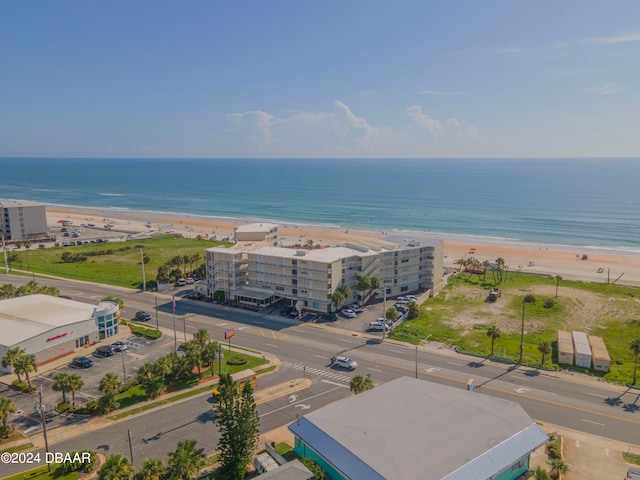 birds eye view of property featuring a beach view and a water view