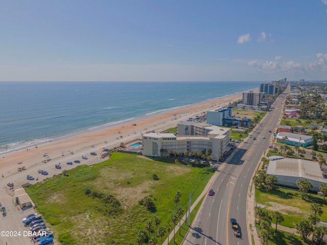 birds eye view of property with a view of the beach and a water view