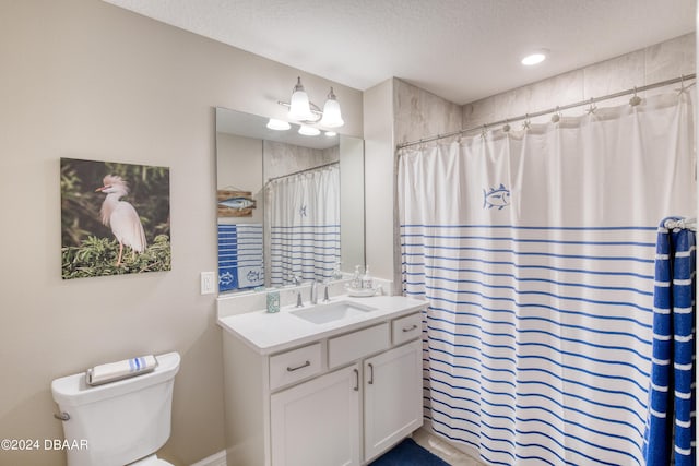 bathroom with vanity, a shower with curtain, a textured ceiling, and toilet