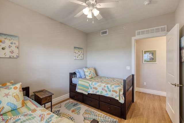 bedroom featuring light hardwood / wood-style floors and ceiling fan