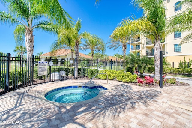 view of swimming pool with a community hot tub