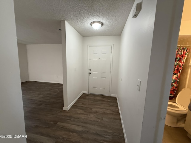 428 Banana Cay Dr Unit G, South Daytona, FL 32119 - corridor with dark wood-type flooring, a textured ceiling, and baseboards