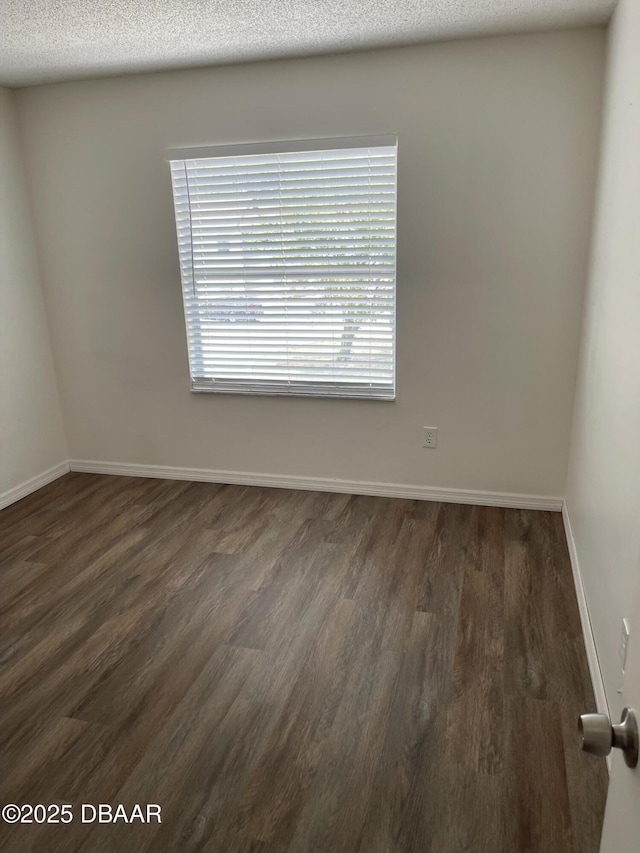 428 Banana Cay Dr Unit G, South Daytona, FL 32119 - unfurnished room with dark wood-type flooring and baseboards