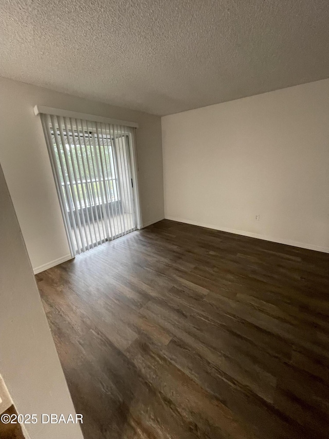 428 Banana Cay Dr Unit G, South Daytona, FL 32119 - unfurnished room featuring dark wood-style flooring and a textured ceiling