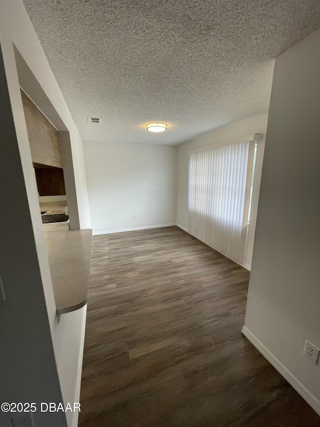 428 Banana Cay Dr Unit G, South Daytona, FL 32119 - spare room featuring baseboards, wood finished floors, and a textured ceiling