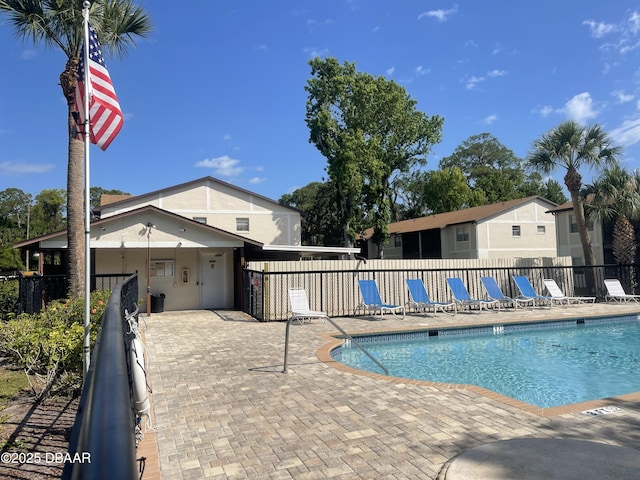 pool featuring fence and a patio