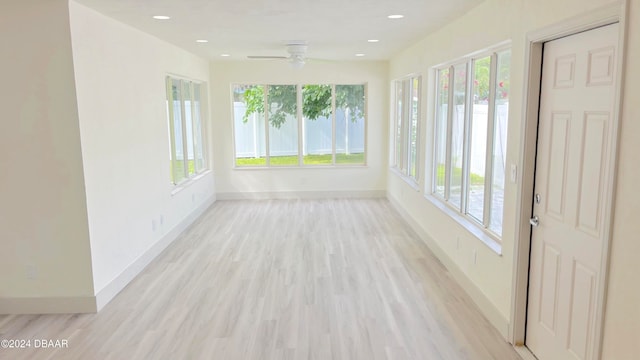 unfurnished sunroom featuring ceiling fan