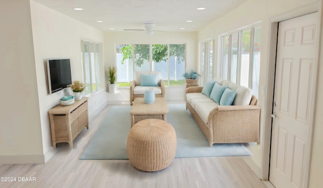 sunroom / solarium featuring ceiling fan