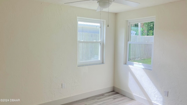 empty room featuring ceiling fan and light hardwood / wood-style flooring