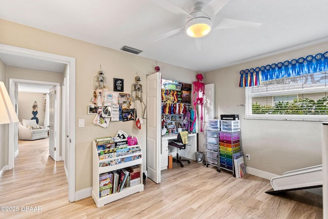 interior space featuring ceiling fan, light wood-style flooring, visible vents, baseboards, and a closet