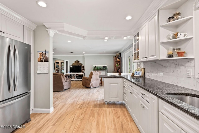 kitchen with white cabinetry, open shelves, crown molding, and freestanding refrigerator