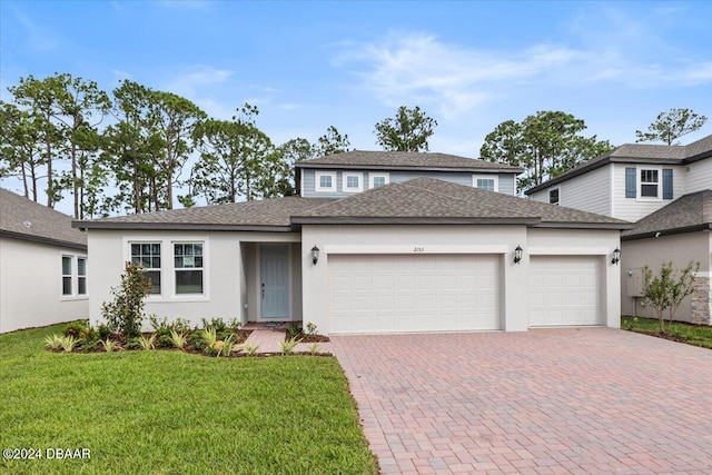 view of front of home with a garage and a front yard