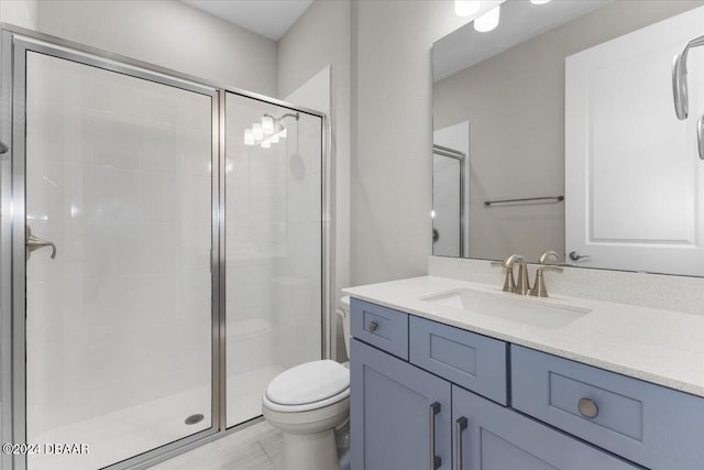 bathroom with a shower with door, vanity, and toilet