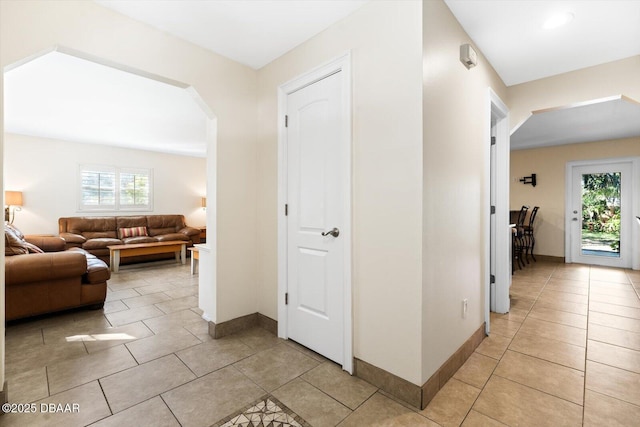 corridor with light tile patterned flooring