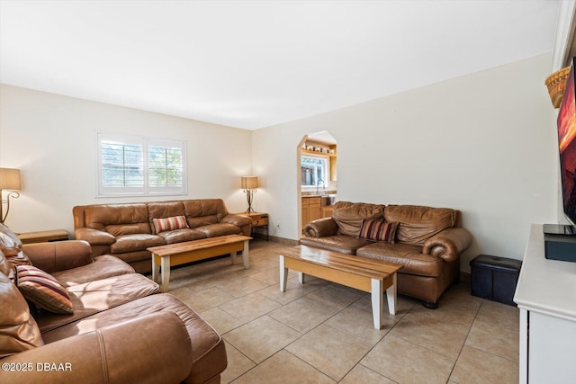 living room with light tile patterned flooring and sink