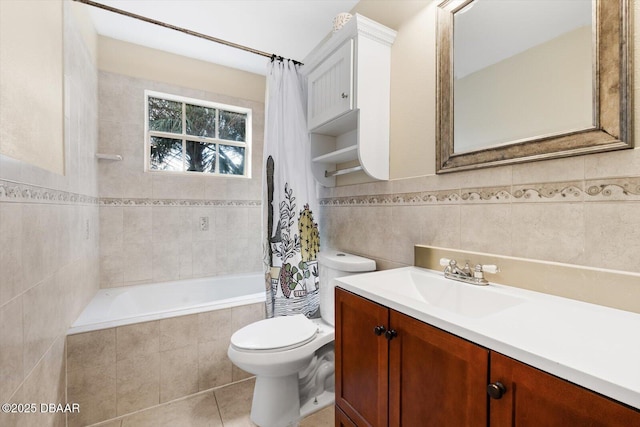 full bathroom featuring shower / tub combo with curtain, tile walls, vanity, toilet, and tile patterned floors