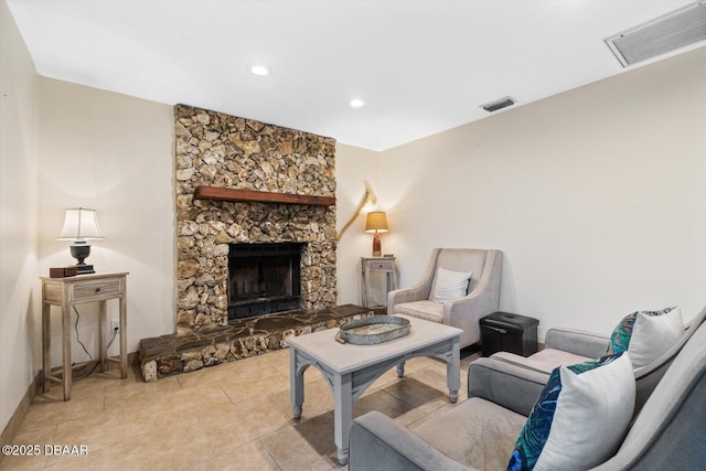 living room with light tile patterned floors and a fireplace