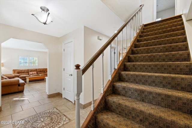 staircase featuring tile patterned flooring