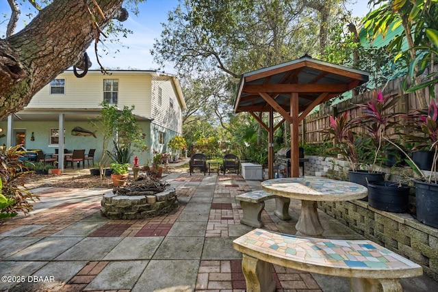 view of patio / terrace with area for grilling and an outdoor fire pit