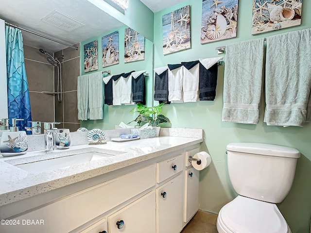 bathroom with toilet, vanity, and a shower with shower curtain