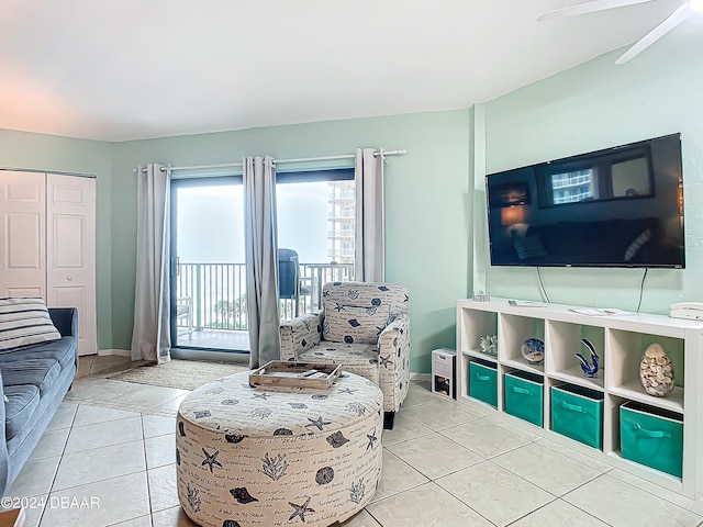 living room featuring light tile patterned floors and ceiling fan