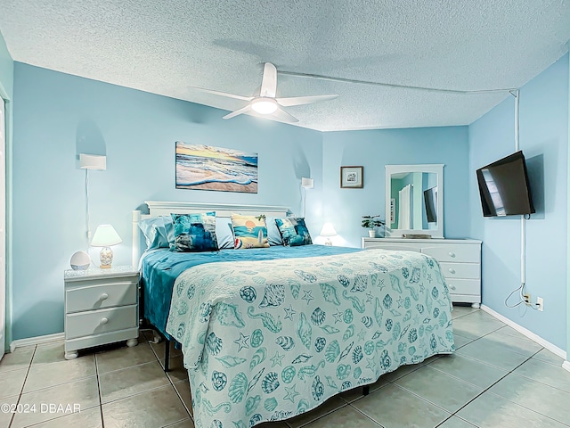 tiled bedroom featuring a textured ceiling and ceiling fan