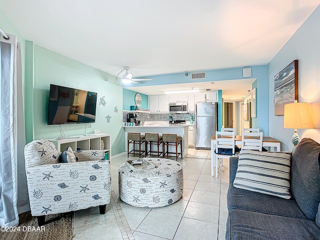 living room featuring light tile patterned flooring and ceiling fan