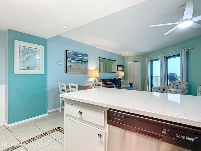 kitchen featuring light stone counters, dishwasher, light tile patterned floors, ceiling fan, and white cabinetry