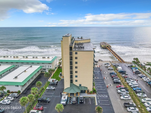 birds eye view of property with a view of the beach and a water view