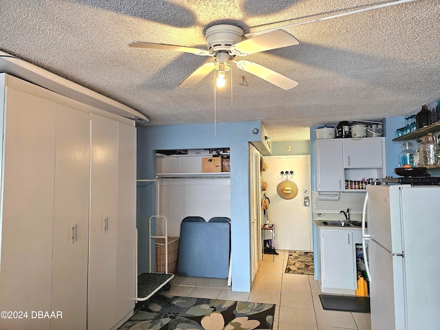 kitchen featuring white cabinetry, ceiling fan, a textured ceiling, and white refrigerator