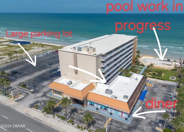 aerial view featuring a water view and a beach view