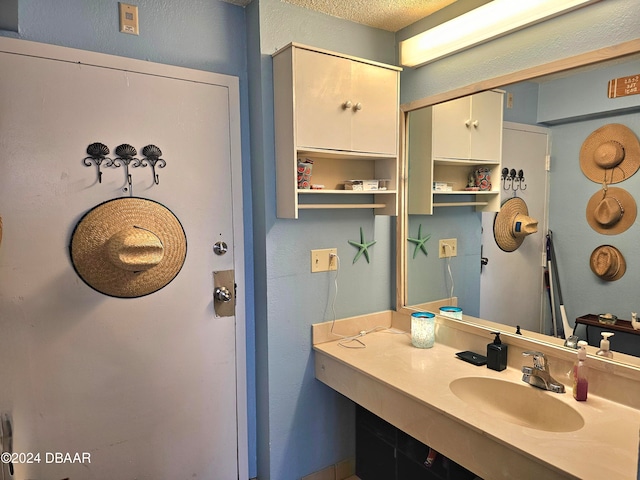 bathroom with a textured ceiling and sink