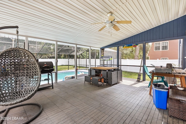 sunroom featuring lofted ceiling, ceiling fan, a swimming pool, and wooden ceiling