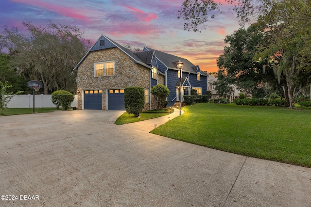 view of front of home featuring a garage and a yard