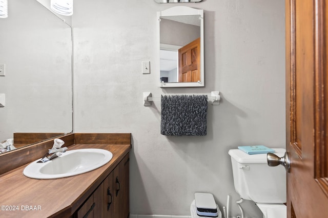 bathroom with toilet and vanity