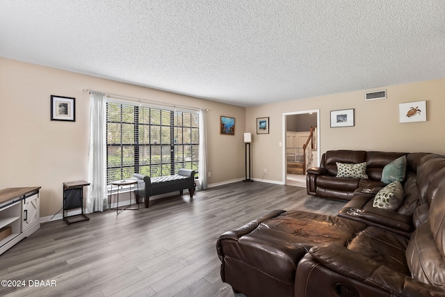 living room featuring hardwood / wood-style floors and a textured ceiling