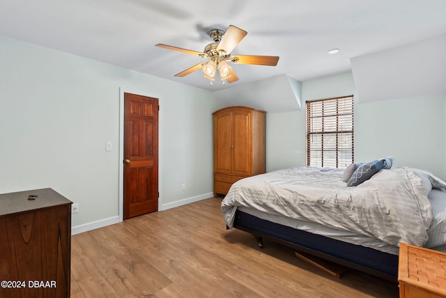 bedroom with ceiling fan and light hardwood / wood-style floors