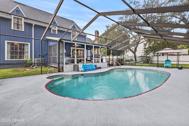 view of pool with a patio area, central AC, and a lanai