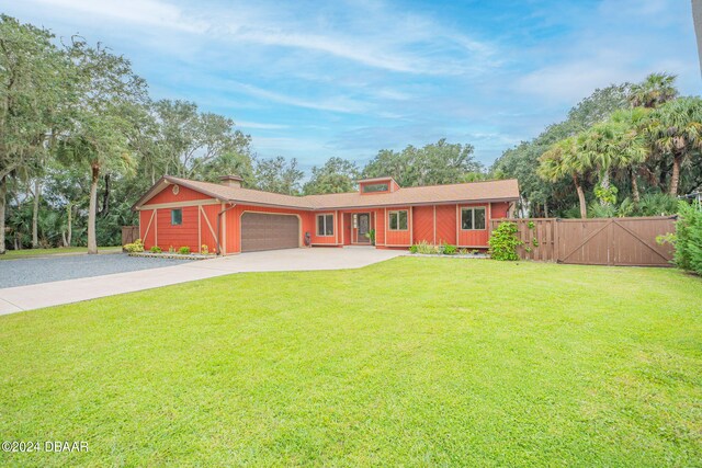 single story home with a garage and a front lawn