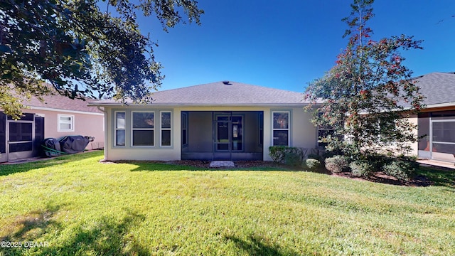 view of front of property with a sunroom and a front yard