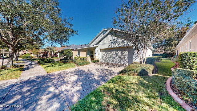 view of front of house featuring a garage and a front lawn