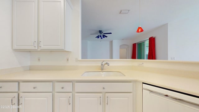 kitchen with sink, ceiling fan, hanging light fixtures, white dishwasher, and white cabinets