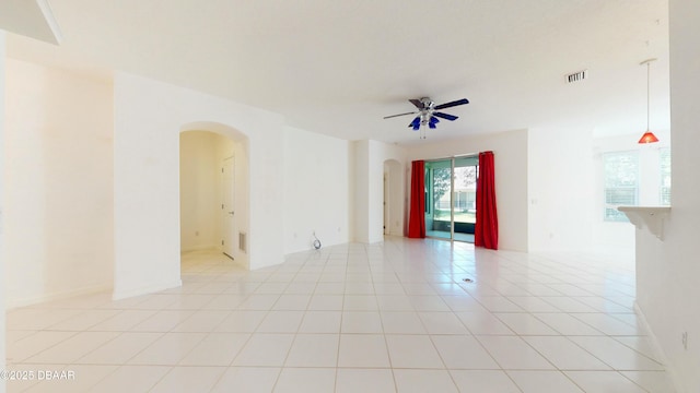 tiled empty room featuring ceiling fan