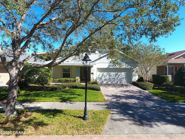 view of front of property featuring a garage and a front lawn